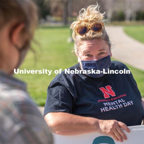 CARE Advocate Melissa Wilkerson speaks to volunteers before setting up their display at the Nebraska Union Greenspace. Flags and signs are placed in the Nebraska Union Greenspace to promote Sexual Assault Awareness Month. April 4, 2021. Photo by Jordan Opp for University Communication.