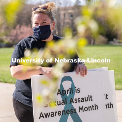 CARE Advocate Melissa Wilkerson speaks to volunteers before setting up their display at the Nebraska Union Greenspace. Flags and signs are placed in the Nebraska Union Greenspace to promote Sexual Assault Awareness Month. April 4, 2021. Photo by Jordan Opp for University Communication.