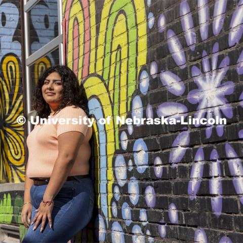 Josselyn Catalan, junior in global studies and ethnic studies, poses by a mural in an alleyway of the Haymarket for an ASEM recruiting story. April 13, 2021. Photo by Craig Chandler / University Communication.  