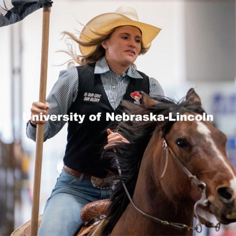 Members of the University of Nebraska rodeo team runs onto the track at the Nebraska Cornhusker College Rodeo at the Lancaster Event Center. April 24, 2021. Photo by Jordan Opp for University Communications.