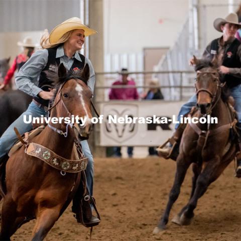 Members of the University of Nebraska rodeo team runs onto the track at the Nebraska Cornhusker College Rodeo at the Lancaster Event Center. April 24, 2021. Photo by Jordan Opp for University Communications.