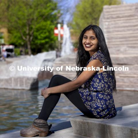 Riha Karney, a Speech-Language Pathologist major, is pictured sitting by the Broyhill fountain outside of the City Union for an ASEM recruiting story. April 29, 2021. Photo by Craig Chandler / University Communication.  
