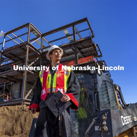 Yajyoo Shrestha, a graduating senior in civil engineering, stands before the construction site of the new College of Education and Human Sciences building on City Campus. April 29, 2021. Photo by Craig Chandler / University Communication.  