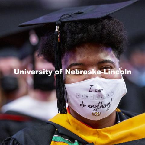Kristina Bayton wears a mask that describes the challenges of the past year and a half. Graduate Commencement at Pinnacle Bank Arena. May 7, 2021. Photo by Craig Chandler / University Communication.