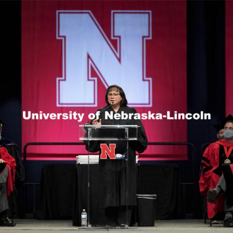 Hon. Riko Bishop, Judge, Nebraska Court of Appeals and a 1992 Nebraska Law graduate, gives the commencement address as UNL Chancellor Ronnie Green and Dean Richard Moberly listen.  College of Law Graduation at Pinnacle Bank Arena. May 7, 2021. Photo by Craig Chandler / University Communication.