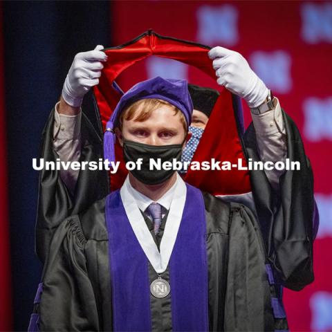 James Glover receives his hood during College of Law Graduation at Pinnacle Bank Arena. May 7, 2021. Photo by Craig Chandler / University Communication.