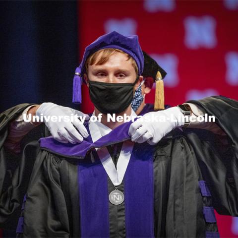 James Glover receives his hood during College of Law Graduation at Pinnacle Bank Arena. May 7, 2021. Photo by Craig Chandler / University Communication.