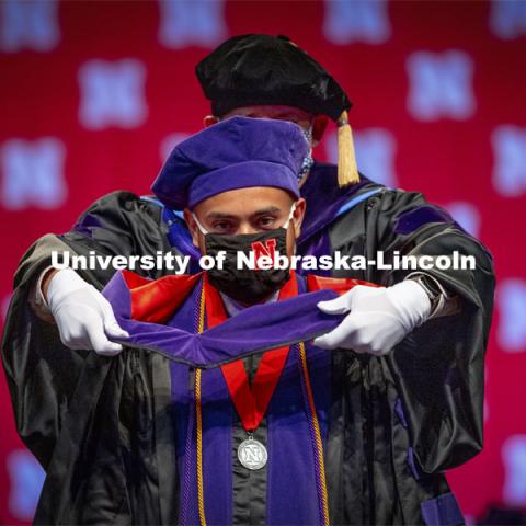 Mauricio Murga Rios receives his hood during College of Law Graduation at Pinnacle Bank Arena. May 7, 2021. Photo by Craig Chandler / University Communication.