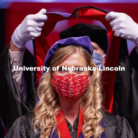 Allison Seiler sports a legal mask as she is hooded. College of Law Graduation at Pinnacle Bank Arena. May 7, 2021. Photo by Craig Chandler / University Communication.