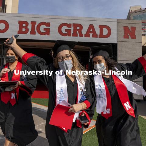 Claire Wiens and Adrienne McDowell cheer as they step on the field Saturday morning. UNL Commencement in Memorial Stadium. May 8, 2021. Photo by Craig Chandler / University Communication.