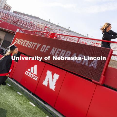 Taylor Bromagen poses while her mom, Kim Pinneo, takes a selfie. UNL Commencement in Memorial Stadium. May 8, 2021. Photo by Craig Chandler / University Communication.