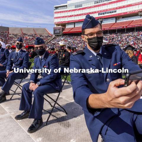 Air Force ROTC Cadet and engineering graduate Hunter Rausch takes a selfie of himself and fellow Air Force cadets before the start of the morning commencement. UNL Commencement in Memorial Stadium. May 8, 2021. Photo by Craig Chandler / University Communication.