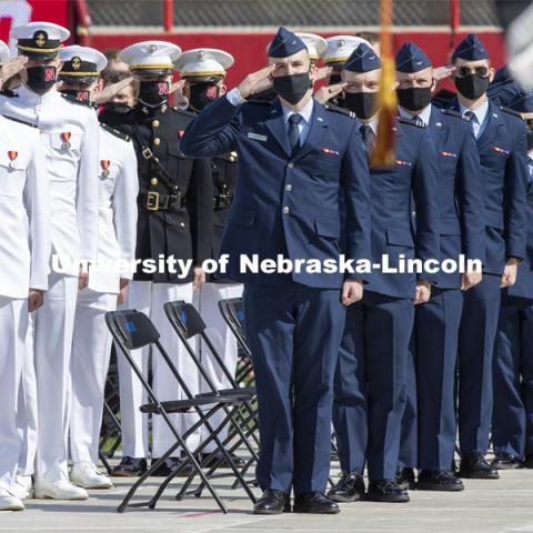 ROTC cadets salute the flag during the national anthem. UNL Commencement in Memorial Stadium. May 8, 2021. Photo by Craig Chandler / University Communication.