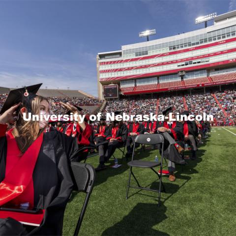 Maddalynne Armstrong waves to family and friends during the ceremony. UNL Commencement in Memorial Stadium. May 8, 2021. Photo by Craig Chandler / University Communication.