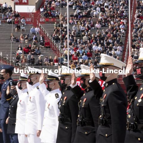 Air Force, Navy Marine and Army ROTC cadets recite the oath of enlistment at the beginning of the morning commencement. The cadets then changed into regalia to graduate with their colleges. The university conferred a record 3,594 degrees during the May commencement ceremonies. UNL Commencement in Memorial Stadium. May 8, 2021. Photo by Craig Chandler / University Communication.