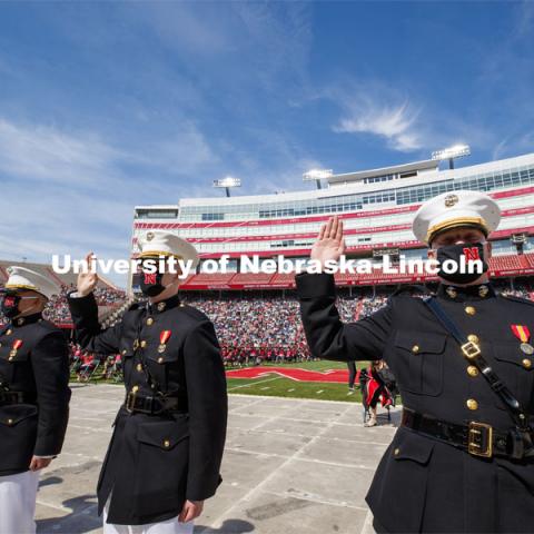 Marine ROTC cadets recite the oath of enlistment at the beginning of the second commencement. The cadets then changed into regalia to graduate with their colleges. The university conferred a record 3,594 degrees during the May commencement ceremonies. UNL Commencement in Memorial Stadium. May 8, 2021. Photo by Craig Chandler / University Communication.