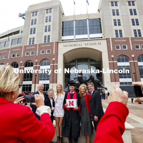 Daniel Pearson and family pose in front of Memorial Stadium following the morning commencement. UNL Commencement in Memorial Stadium. May 8, 2021. Photo by Craig Chandler / University Communication.