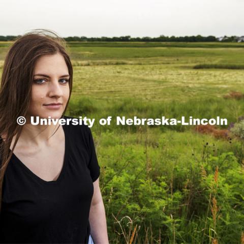 Nicole Fiore, a graduate student in biological sciences, is studying methanogens, a type of methane-producing microorganism, that lives in the wetlands in north Lincoln and could possibly live on Mars. Fiore is pictured by the wetlands behind Cracker Barrel on North 27th Street. June 24, 2021. Photo by Craig Chandler / University Communication.