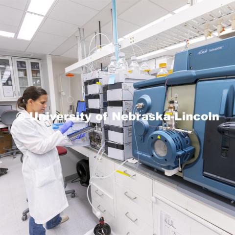 Lab Manager Anne Fischer works with a spectrometer in the background in the Proteomics and Metabolomics lab in Beadle Hall. Nebraska Center for Biotechnology. June 25, 2021. Photo by Craig Chandler / University Communication.