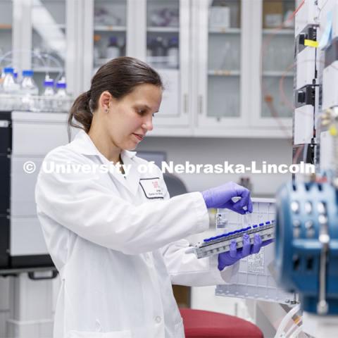 Lab Manager Anne Fischer works with a spectrometer in the background in the Proteomics and Metabolomics lab in Beadle Hall. Nebraska Center for Biotechnology. June 25, 2021. Photo by Craig Chandler / University Communication.