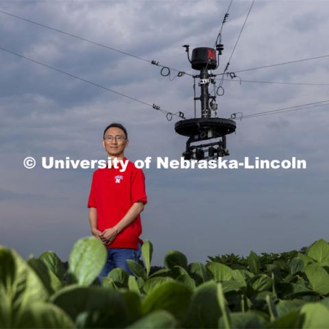 Yufeng Ge, Associate Professor of Biological Systems Engineering, is advancing high-tech plant phenotyping to study plant’s physical traits, leading to improved yields, drought resistance. He is photographed in the spider cam field near Mead, Nebraska. July 8, 2021. Photo by Craig Chandler / University Communication.