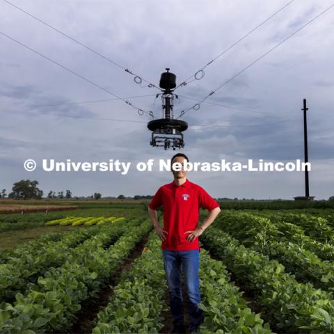 Yufeng Ge, Associate Professor of Biological Systems Engineering, is advancing high-tech plant phenotyping to study plant’s physical traits, leading to improved yields, drought resistance. He is photographed in the spider cam field near Mead, Nebraska. July 8, 2021. Photo by Craig Chandler / University Communication.