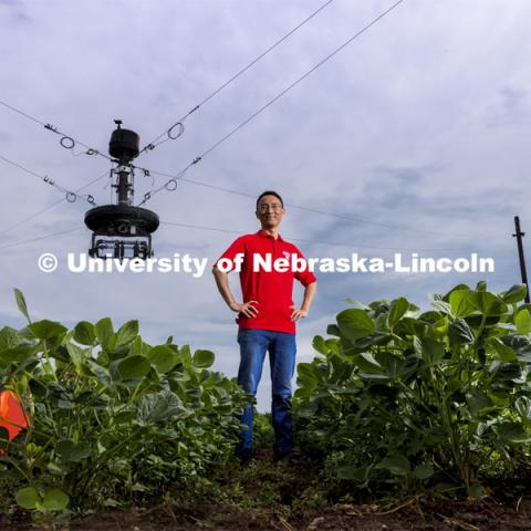 Yufeng Ge, Associate Professor of Biological Systems Engineering, is advancing high-tech plant phenotyping to study plant’s physical traits, leading to improved yields, drought resistance. He is photographed in the spider cam field near Mead, Nebraska. July 8, 2021. Photo by Craig Chandler / University Communication.