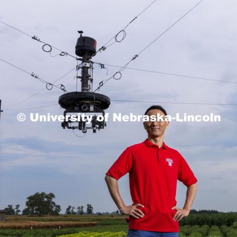 Yufeng Ge, Associate Professor of Biological Systems Engineering, is advancing high-tech plant phenotyping to study plant’s physical traits, leading to improved yields, drought resistance. He is photographed in the spider cam field near Mead, Nebraska. July 8, 2021. Photo by Craig Chandler / University Communication.