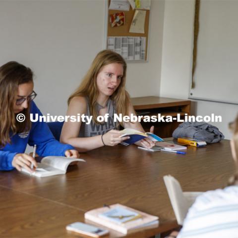 Sarah Hawkinson (blue shirt) and Kaylen Michaelis (tank top) discuss the first few chapters of “O Pioneers!” with their instructor, Emily Rau.Studying Willa Cather at Cedar Point Biological Station near Ogallala, Nebraska. July 19, 2021. Photo by Annie Albin / University Communication