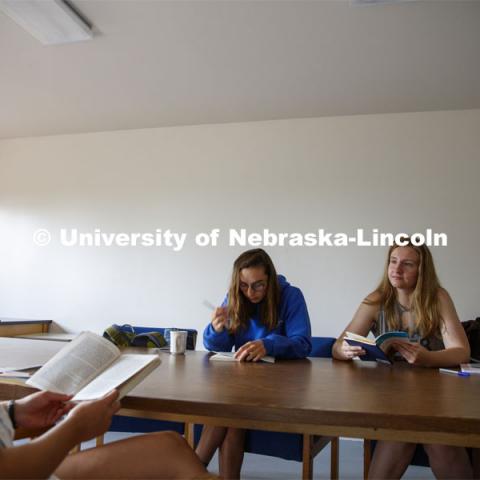Sarah Hawkinson (blue shirt) and Kaylen Michaelis (tank top) discuss the first few chapters of “O Pioneers!” with their instructor, Emily Rau.Studying Willa Cather at Cedar Point Biological Station near Ogallala, Nebraska. July 19, 2021. Photo by Annie Albin / University Communication