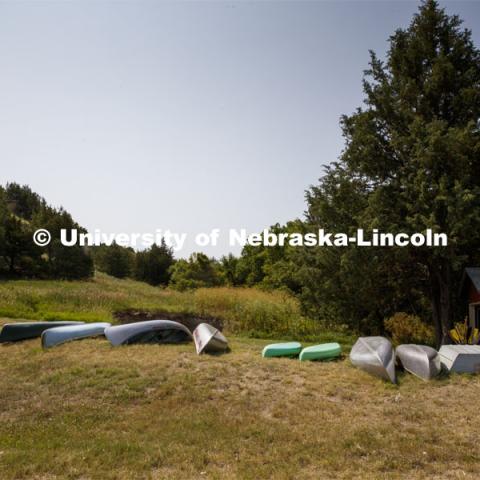 Canoes, kayaks, and boats line the shore for waterfront activities at Cedar Point Biological Station near Ogallala, Nebraska. July 19, 2021. Photo by Annie Albin / University Communication.