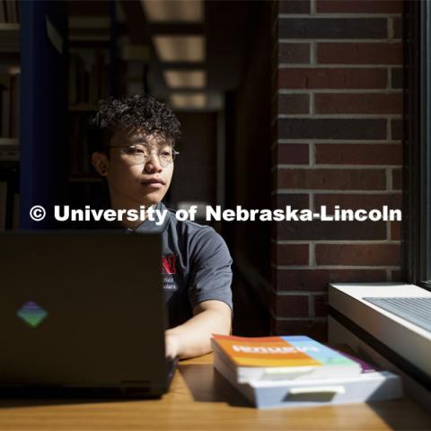 Daniel Nguyen, McNair scholar and senior in psychology, studies in Love Library. July 28, 2021. Photo by Craig Chandler / University Communication.