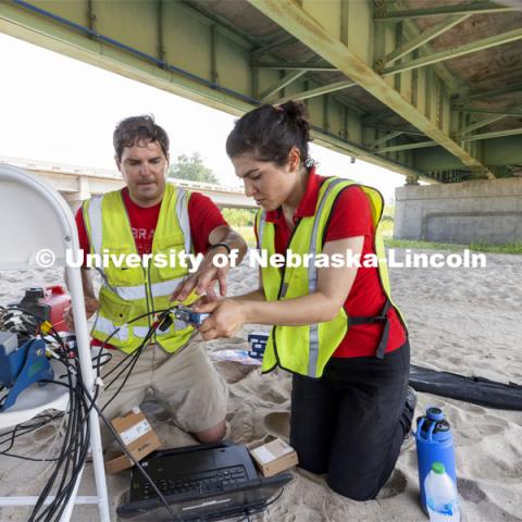 Ricky Woods, Associate Professor of Civil and Environmental Engineering, and Mitra Nasimi replace a sensor box connected to dozens of sensors attached to the aging Platte River Bridge. NOBL, the Nebraska Outdoor Bridge Lab as part of the College of Engineering is turning two bridge sites (for a total of three bridges) into a national research and educational facility for bridge health and testing. This bridge is across the Platte River on Highway 92 between Yutan and Omaha. August 9, 2021. Photo by Craig Chandler / University Communication.