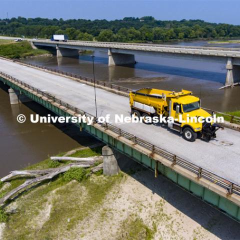 A Nebraska Department of Transportation truck drives across the aging Platte River Bridge as sensors record the movement and vibrations of the bridge. Trucks drove across the bridge singularly and in unison numerous times at varying speeds so the sensors could collect data for each of the runs. NOBL, the Nebraska Outdoor Bridge Lab as part of the College of Engineering is turning two bridge sites (for a total of three bridges) into a national research and educational facility for bridge health and testing. This bridge is across the Platte River on Highway 92 between Yutan and Omaha. August 9, 2021. Photo by Craig Chandler / University Communication.