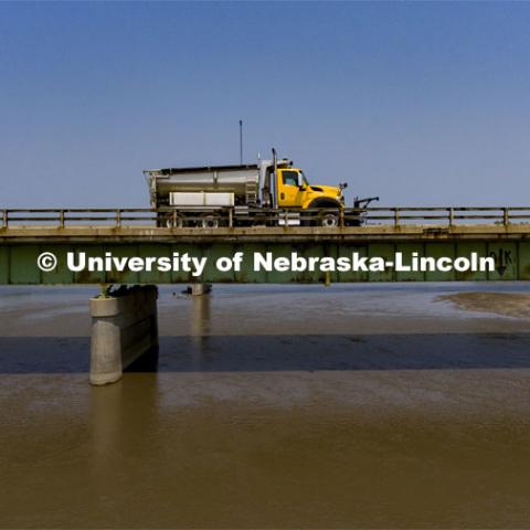A Nebraska Department of Transportation truck drives across the aging Platte River Bridge as sensors record the movement and vibrations of the bridge. Trucks drove across the bridge singularly and in unison numerous times at varying speeds so the sensors could collect data for each of the runs. NOBL, the Nebraska Outdoor Bridge Lab as part of the College of Engineering is turning two bridge sites (for a total of three bridges) into a national research and educational facility for bridge health and testing. This bridge is across the Platte River on Highway 92 between Yutan and Omaha. August 9, 2021. Photo by Craig Chandler / University Communication.