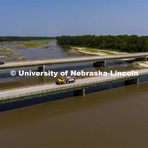 A Nebraska Department of Transportation truck drives across the aging Platte River Bridge as sensors record the movement and vibrations of the bridge. Trucks drove across the bridge singularly and in unison numerous times at varying speeds so the sensors could collect data for each of the runs. NOBL, the Nebraska Outdoor Bridge Lab as part of the College of Engineering is turning two bridge sites (for a total of three bridges) into a national research and educational facility for bridge health and testing. This bridge is across the Platte River on Highway 92 between Yutan and Omaha. August 9, 2021. Photo by Craig Chandler / University Communication.