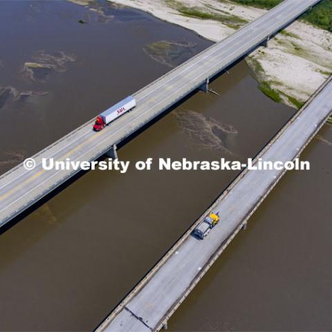 A Nebraska Department of Transportation truck drives across the aging Platte River Bridge as sensors record the movement and vibrations of the bridge. Trucks drove across the bridge singularly and in unison numerous times at varying speeds so the sensors could collect data for each of the runs. NOBL, the Nebraska Outdoor Bridge Lab as part of the College of Engineering is turning two bridge sites (for a total of three bridges) into a national research and educational facility for bridge health and testing. This bridge is across the Platte River on Highway 92 between Yutan and Omaha. August 9, 2021. Photo by Craig Chandler / University Communication.