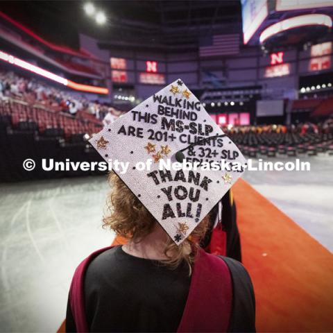 Emma Loberg’s decorated mortar board thanks all who made her speech-language pathology masters degree possible. Summer Graduate Commencement at Pinnacle Bank Arena. August 13, 2021. Photo by Craig Chandler / University Communication.