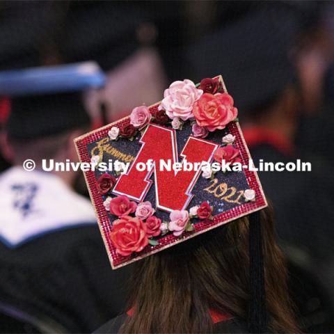 Decorated mortar boards at commencement. Undergraduate Commencement at Pinnacle Bank Arena. August 14, 2021. Photo by Craig Chandler / University Communication.