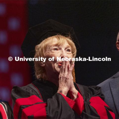 Leta Powell Drake, local television pioneer and Husker alumna, watches a video about her career on the scoreboard. Drake was presented with an honorary Doctor of Humane Letters during the undergraduate ceremony. Her son, Aaron Drake, watches with her. Undergraduate Commencement at Pinnacle Bank Arena. August 14, 2021. Photo by Craig Chandler / University Communication.