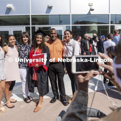 Noele Smith poses for her grandmother outside of Pinnacle Bank Arena. Undergraduate Commencement at Pinnacle Bank Arena. August 14, 2021. Photo by Craig Chandler / University Communication.