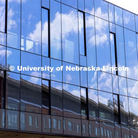 Jorgensen Hall is reflected in the Phase 1 facade of the Scott Engineering Center renovations. August 15, 2021. Photo by Craig Chandler / University Communication.