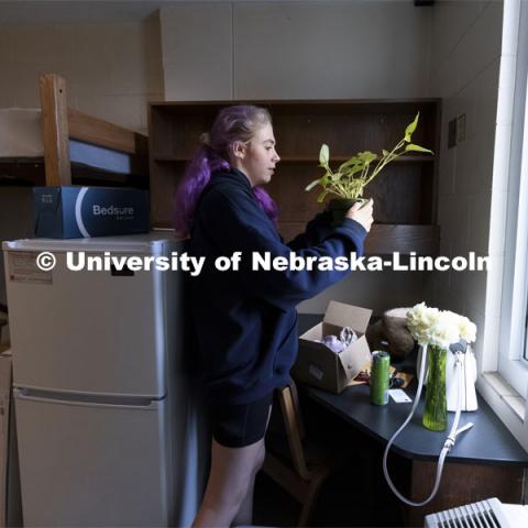 Robin Lindemann, a First Husker from Arlington, TX, checks to see how her plants survived the drive from Texas to her Schramm residence hall. Early arrival move-in for sorority rush, First Husker and Emerging Leaders. August 15, 2021. Photo by Craig Chandler / University Communication.