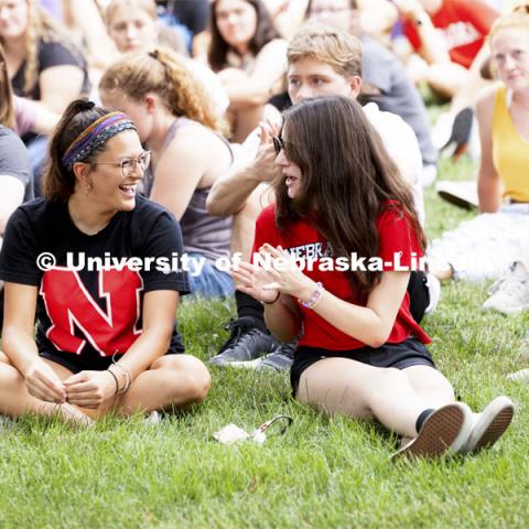 Isabella Villanueva center, of Lincoln, talks with Jordan Bares of Lakeville, Minnesota, at the This is CASNR welcome event on East Campus. August 19, 2021. Photo by Craig Chandler / University Communication.