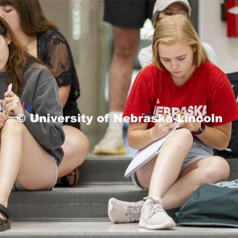 The last students in the door of Chemistry 110 lecture in Hamilton Hall chose to sit on the steps rather than work their way into the seats. First day of classes for fall semester. August 23, 2021. Photo by Craig Chandler / University Communication.