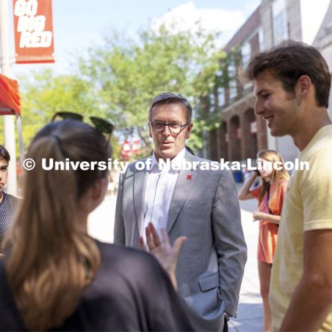 Chancellor Ronnie Green talks with students including Josh Rodriguez, left, and Ryan Thomas, right, at the Inaugural Soph S’more Social outside of the Nebraska Union. A special Dairy Store flavor was given out to sophomores, friends of sophomores, and anyone who was once a sophomore to celebrate them being back on campus. August 25, 2021. Photo by Craig Chandler / University Communication.