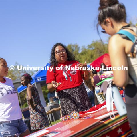 Nasia Olson-White Feather of Red Lake, MN, talks with a student at the UNITE table as Jaicein Mayfield listens in. Club Fair at City Campus. More than 130 recognized student organizations (RSOs) to join for social, professional and leadership interests. RSO members and officers will be on hand to provide details about their organization and answer questions from prospective new members. August 25, 2021. Photo by Craig Chandler / University Communication.