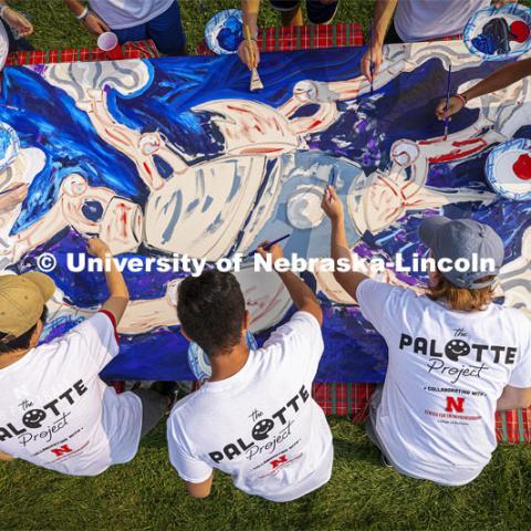 Students paint “Lift Off”, during an entrepreneurial community mural painting in the green space outside the Nebraska Union. The student-created design will be hung in the College of Business. September 1, 2021. Photo by Craig Chandler / University Communication.