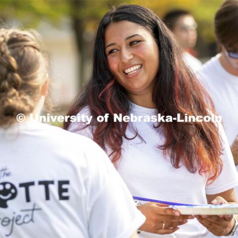 Erika Casarin, senior management major, CEO and founder of the The PALETTE Project talks with a volunteer painter. Students paint “Lift Off”, during an entrepreneurial community mural painting in the green space outside the Nebraska Union. The student-created design will be hung in the College of Business. September 1, 2021. Photo by Craig Chandler / University Communication.