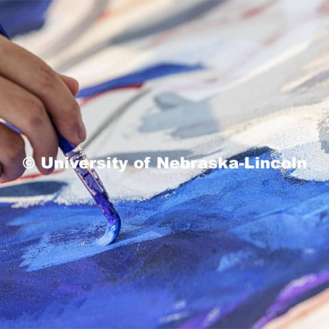 Students paint “Lift Off”, during an entrepreneurial community mural painting in the green space outside the Nebraska Union. The student-created design will be hung in the College of Business. September 1, 2021. Photo by Craig Chandler / University Communication.